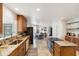 Spacious kitchen features granite countertops, wooden cabinetry, and stainless steel appliances at 3810 Hidden River Rd, Sarasota, FL 34240