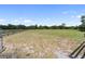Large grassy parcel of land with a wooden fence surrounding the property at 3810 Hidden River Rd, Sarasota, FL 34240