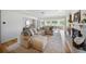 Cozy living room featuring a fireplace, sectional sofa, and an open floor plan at 3810 Hidden River Rd, Sarasota, FL 34240