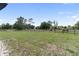 Large grassy pasture with mature trees and wooden fencing provides a serene country setting at 3810 Hidden River Rd, Sarasota, FL 34240