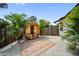 A beautifully designed patio with a wooden sauna, potted palms, and a stylish rug, perfect for relaxation and outdoor enjoyment at 3810 Hidden River Rd, Sarasota, FL 34240