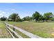 Expansive, well-maintained property featuring a wooden fence, a home in the background, and mature trees for added privacy at 3810 Hidden River Rd, Sarasota, FL 34240
