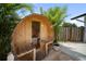Outdoor barrel sauna with a glass door and wood benches nestled among palm trees at 3810 Hidden River Rd, Sarasota, FL 34240