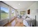 Bright sitting area with hardwood floors, comfortable chairs, and views of the fenced pasture at 3810 Hidden River Rd, Sarasota, FL 34240