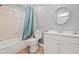 Standard bathroom with a shower-tub combo, white cabinets, and a round mirror over the sink at 3901 41St W St, Bradenton, FL 34205
