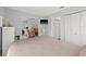 Cozy bedroom with view to the living room, including a TV and closet with louvered doors at 3901 41St W St, Bradenton, FL 34205