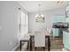 Bright dining area with a modern light fixture, ample seating, and a view into the kitchen at 3901 41St W St, Bradenton, FL 34205