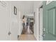 Inviting hallway with wood floors leading to the living area of the home with a door on the left at 3901 41St W St, Bradenton, FL 34205