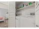 Conveniently located laundry room with a washer, dryer, and shelving for storage at 3901 41St W St, Bradenton, FL 34205