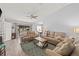 Spacious living room featuring modern furniture, a ceiling fan, and natural light from the sliding glass door at 3901 41St W St, Bradenton, FL 34205
