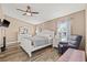 Primary bedroom with wood-look floors, fan, and natural light at 3901 41St W St, Bradenton, FL 34205
