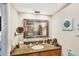 Bathroom features a granite vanity, decorative mirror, and tiled shower at 3914 Glen Oaks Manor Dr, Sarasota, FL 34232