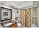 Well-maintained bathroom features granite vanity and shower with decorative curtain at 3914 Glen Oaks Manor Dr, Sarasota, FL 34232