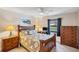 Comfortable bedroom with wood furniture, lamps, and a window view at 3914 Glen Oaks Manor Dr, Sarasota, FL 34232
