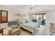 Relaxing bedroom with cozy seating, ceiling fan and access to outdoor patio at 3914 Glen Oaks Manor Dr, Sarasota, FL 34232