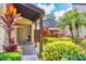 Landscaped front entrance featuring tropical plants, decorative walkway, and an inviting covered porch at 3914 Glen Oaks Manor Dr, Sarasota, FL 34232