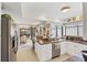 Modern kitchen with granite countertops, stainless steel appliances, and view to dining room at 3914 Glen Oaks Manor Dr, Sarasota, FL 34232