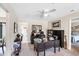 Well-lit home office with ceiling fan, dark wood desk, and black shelving for a professional and productive workspace at 3914 Glen Oaks Manor Dr, Sarasota, FL 34232