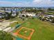 Aerial view of the community park featuring a baseball diamond, tennis courts, and green spaces at 407 63Rd St, Holmes Beach, FL 34217