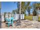 Backyard patio area with a small blue table, chairs, and crushed rock at 407 63Rd St, Holmes Beach, FL 34217