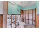 Partially renovated turquoise bathroom features wood studs and exposed pipes at 407 63Rd St, Holmes Beach, FL 34217
