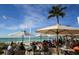 Beachside dining with tables and umbrellas overlooking the ocean at 407 63Rd St, Holmes Beach, FL 34217