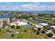 Aerial view of community park featuring tennis and pickleball courts, playground, and waterfront access at 407 63Rd St, Holmes Beach, FL 34217