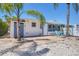 Charming home exterior with stone patio and beautiful palm trees at 407 63Rd St, Holmes Beach, FL 34217
