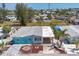 Eye-level view of quaint coastal home with car port, tropical landscaping and colorful exterior at 407 63Rd St, Holmes Beach, FL 34217