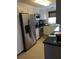 Well-lit kitchen showcasing stainless steel appliances, granite countertops, and white cabinets at 407 63Rd St, Holmes Beach, FL 34217