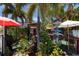 Whimsical outdoor seating area with lush greenery, pink flamingos and unique signage at 407 63Rd St, Holmes Beach, FL 34217
