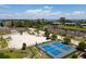 Aerial view of pickleball and tennis courts with nearby community amenities in a lush, tropical setting near the ocean at 407 63Rd St, Holmes Beach, FL 34217