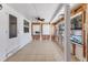 Tiled sun room with white ceiling, ceiling fan, and white-framed windows at 407 63Rd St, Holmes Beach, FL 34217