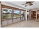 Tiled sun room with bright windows offering views of the landscaped yard at 407 63Rd St, Holmes Beach, FL 34217