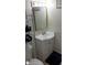 Modest bathroom featuring a vanity, toilet, and storage shelving for organizational needs at 4154 Heron Way # 203B, Bradenton, FL 34205