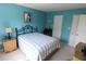 Charming bedroom with blue walls, a comfortable bed, and stylish bedside tables at 4154 Heron Way # 203B, Bradenton, FL 34205