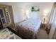 Cozy bedroom with a beachy theme, featuring a comfortable bed and calming artwork at 4154 Heron Way # 203B, Bradenton, FL 34205