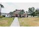 Charming community center with inviting entrance, manicured lawn and golf cart parking at 4154 Heron Way # 203B, Bradenton, FL 34205
