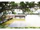 Peaceful view of a wooden dock extending into a tranquil lake surrounded by lush greenery at 4154 Heron Way # 203B, Bradenton, FL 34205