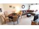 Open-concept living and dining area with comfortable seating and a dining table set for entertaining at 4154 Heron Way # 203B, Bradenton, FL 34205
