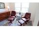 Comfortable sitting area with two chairs, ottomans, a decorative rug, and natural light at 4154 Heron Way # 203B, Bradenton, FL 34205