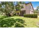 Relax in this backyard featuring lush lawn and mature landscaping for privacy and tranquility at 4220 Via Piedra Cir # 4-101, Sarasota, FL 34233