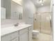 Clean bathroom with a vanity, large mirror, and glass-enclosed shower at 4220 Via Piedra Cir # 4-101, Sarasota, FL 34233