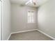 Bedroom features neutral carpet, a ceiling fan, and shuttered window for natural light at 4220 Via Piedra Cir # 4-101, Sarasota, FL 34233
