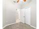 Carpeted bedroom with double closet, neutral colors, and view into hallway at 4220 Via Piedra Cir # 4-101, Sarasota, FL 34233