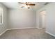 Spacious bedroom with neutral carpet, ceiling fan, and a bright window at 4220 Via Piedra Cir # 4-101, Sarasota, FL 34233