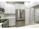 Kitchen featuring stainless steel refrigerator and appliances and white cabinets at 4220 Via Piedra Cir # 4-101, Sarasota, FL 34233