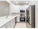 Bright kitchen featuring white cabinetry, stainless steel appliances, and a stylish faucet at 4220 Via Piedra Cir # 4-101, Sarasota, FL 34233