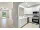 Open kitchen with white cabinets, stainless appliances, and a view into the living area at 4220 Via Piedra Cir # 4-101, Sarasota, FL 34233