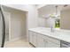 Open kitchen with white cabinets overlooking the living room and backyard at 4220 Via Piedra Cir # 4-101, Sarasota, FL 34233